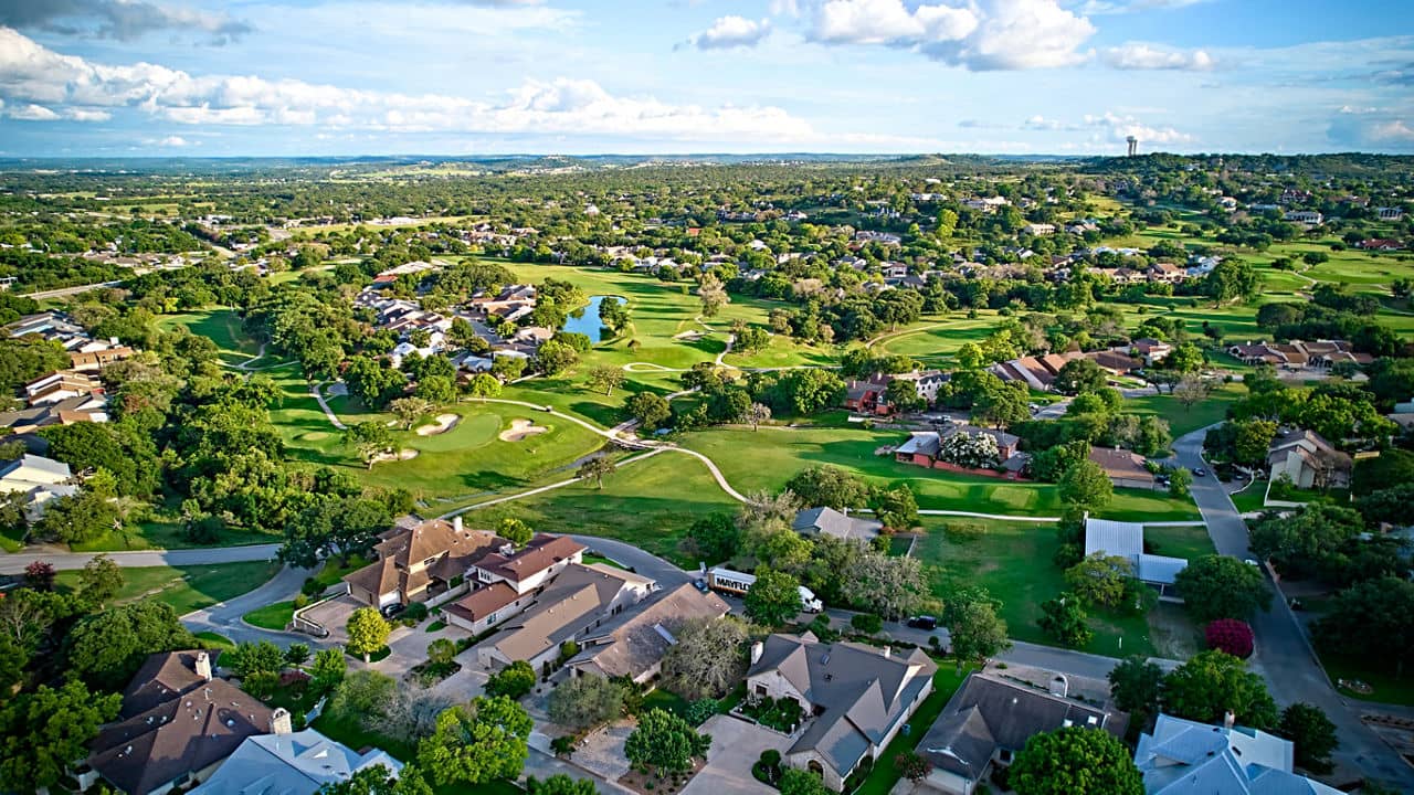 A bird's-eye view of the surroundings of residential buildings and beautiful green fields. Houston, Texas, USA